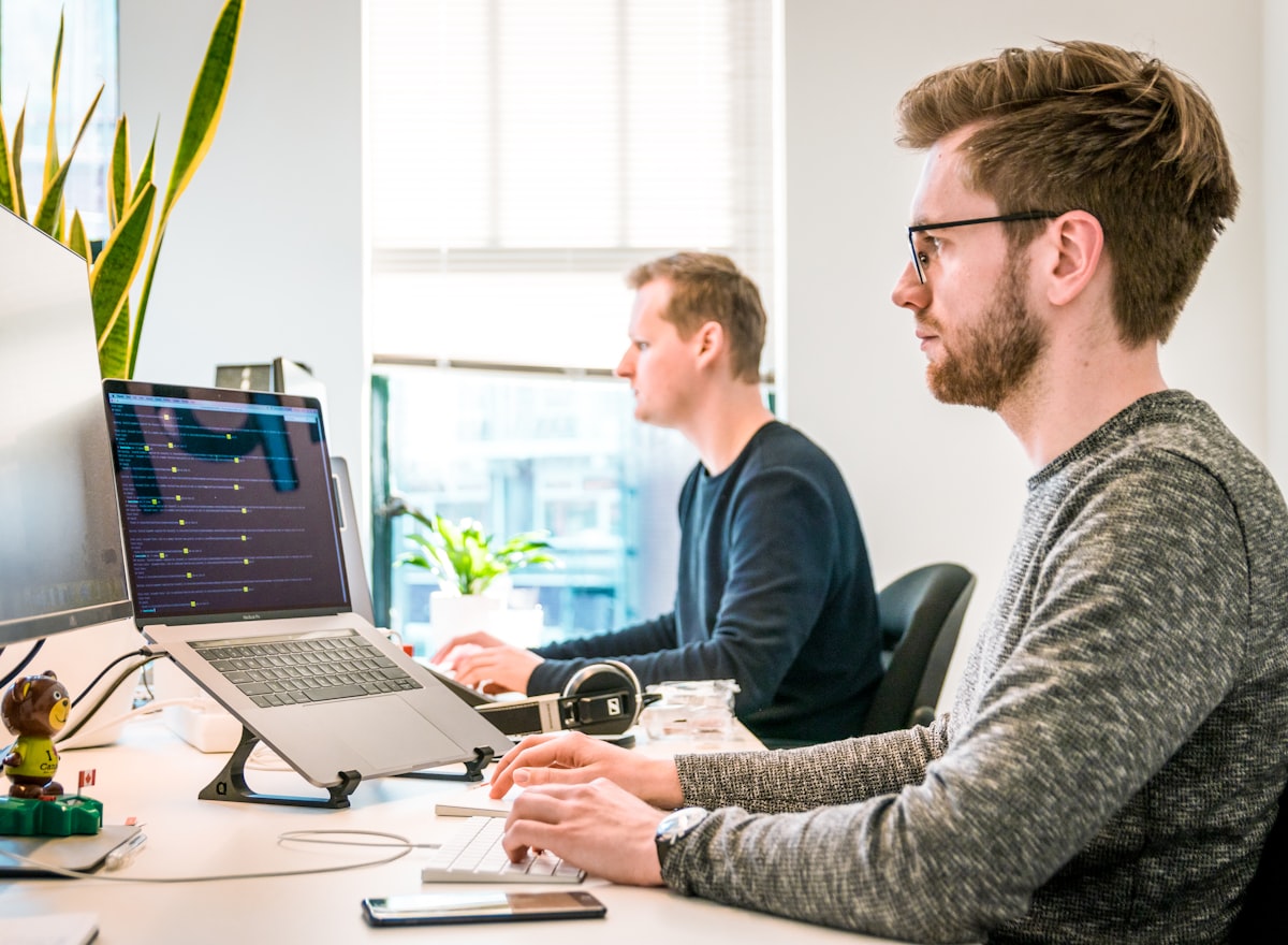 A marketer reviewing site metrics across two screens