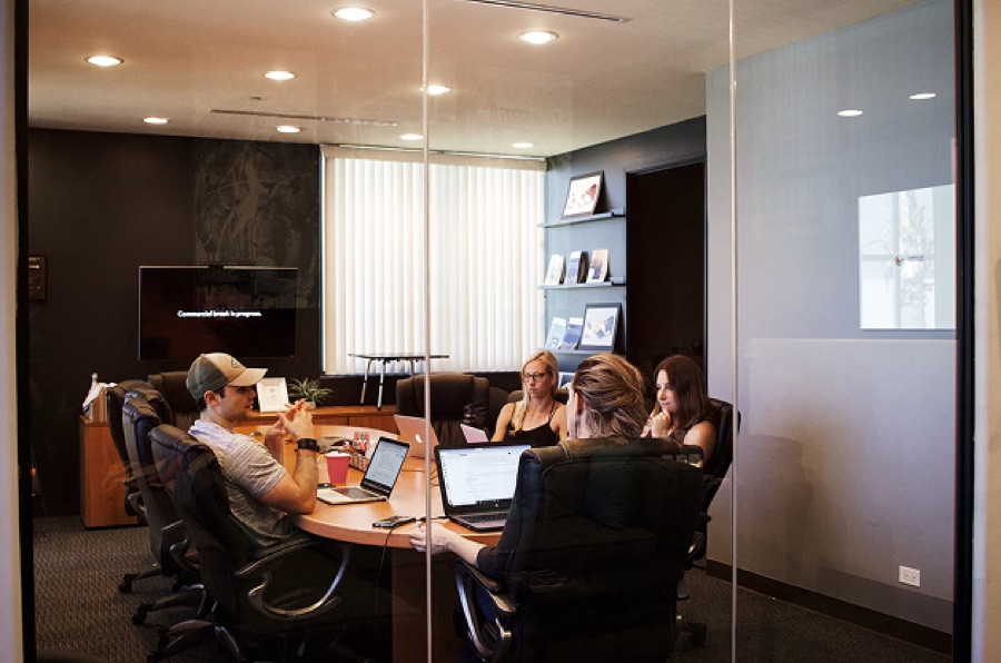 An agency team working in a glass-walled office