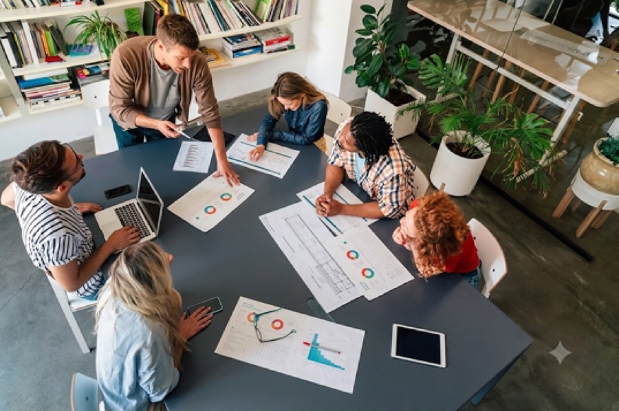 An independent marketer reviewing campaign reports with a team